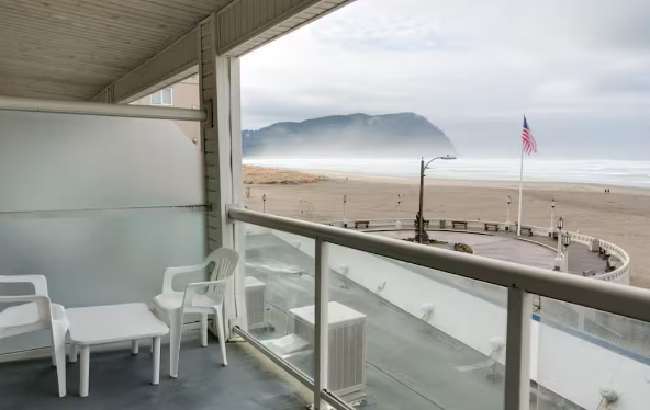 Balcony with a table and two chairs with an ocean view